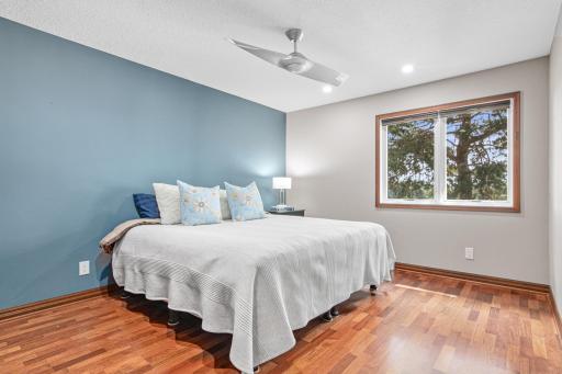 One of 4 bedrooms upstairs with incredible views of the lake and fun outside.