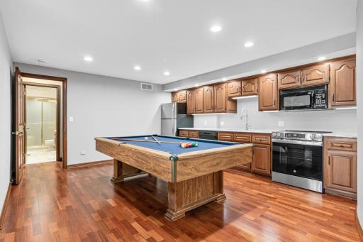 Hosting is a breeze with a second full kitchen and rec room just steps away. Complete with full-size appliances, ample prep space. This lower-level kitchen is perfect for parties or some extra fun.