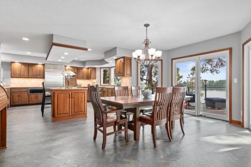Just steps away, sliding doors open to the deck, so serving meals outdoors is as effortless as the breeze off the water.