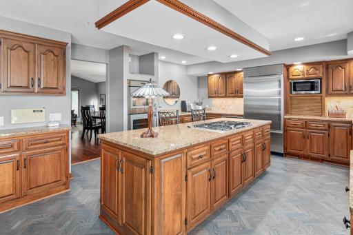 The open-concept kitchen is a hostâs dreamâfully stocked, with bar seating for casual bites and a large dining table for group meals. Abundant cabinetry and counter space allow for multiple cooks in the kitchen!