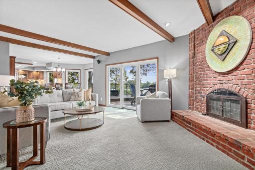 A serene, sun-filled family room where the lake feels like part of the decor and with breathtaking views of the water, creating a peaceful, ever-changing backdrop from sunrise to sunset.