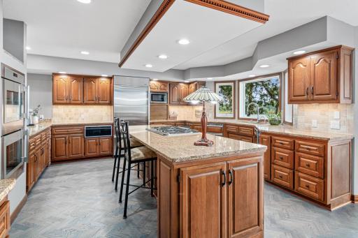 Cook, dine, and gather in a kitchen where the view steals the show. A large island with bar seating invites conversation while keeping the chef in the heart of the action.