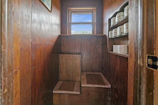 Last stop on the main floor tour is the attached privy, a.k.a. 1/4 bath.. It is a manual load-out. There is a bin behind the seats for cedar shavings or sawdust.