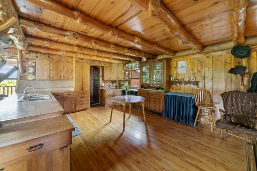 Another view of the kitchen showing cabinets and short hallway to a large pantry.