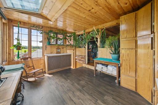 The Sunroom is a major focal point for the main level. Full-height cabinets are not attached, and do not convey with the property. But, notice the plant above the doorway arch.