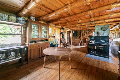 Another view of the kitchen showing the wood fired stove and oven, entry and stairwell.