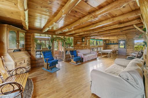 Sitting room and view of dining room. Ample natural light with so many South-Facing windows. Cross breezes from Western and Eastern facing windows keep the inside cool. Notice the plant over the archway, we will talk about that in a slide or two.