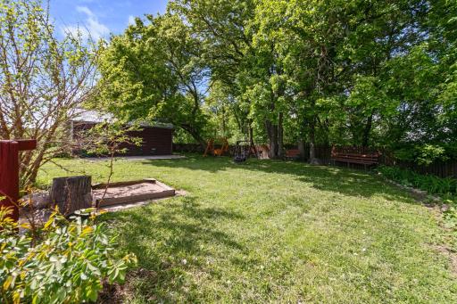 View of side yard, tool shed with lean-to for wood storage. Well built double-room privy is behind the shed.