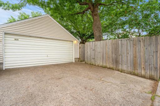 Alley access to the detached two-stall garage. You can access the yard through the garage or through the fence.