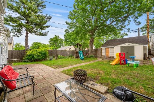 Spacious private backyard with room to play and entertain with easy access to the two-stall garage ans storage shed.