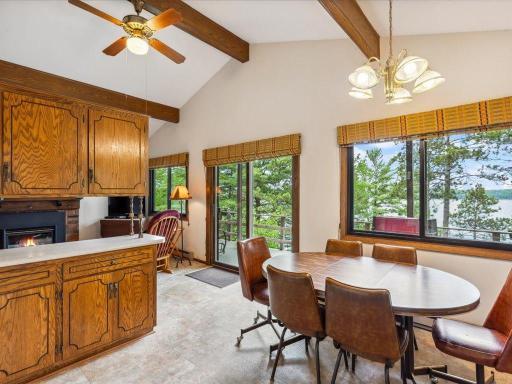 Sunlight floods the wood beamed vaulted main level living area with panoramic lake views.