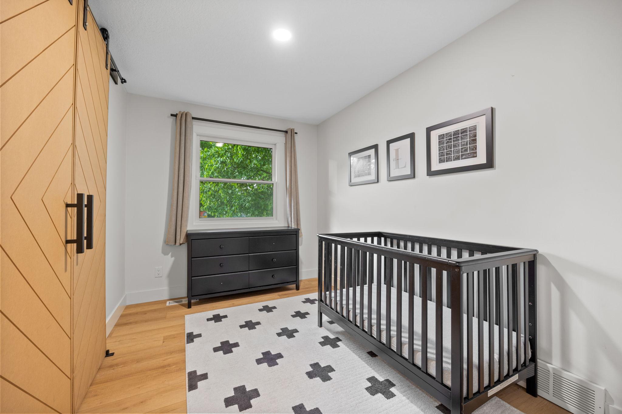 Main level bedroom with custom closet doors and closet organization system.