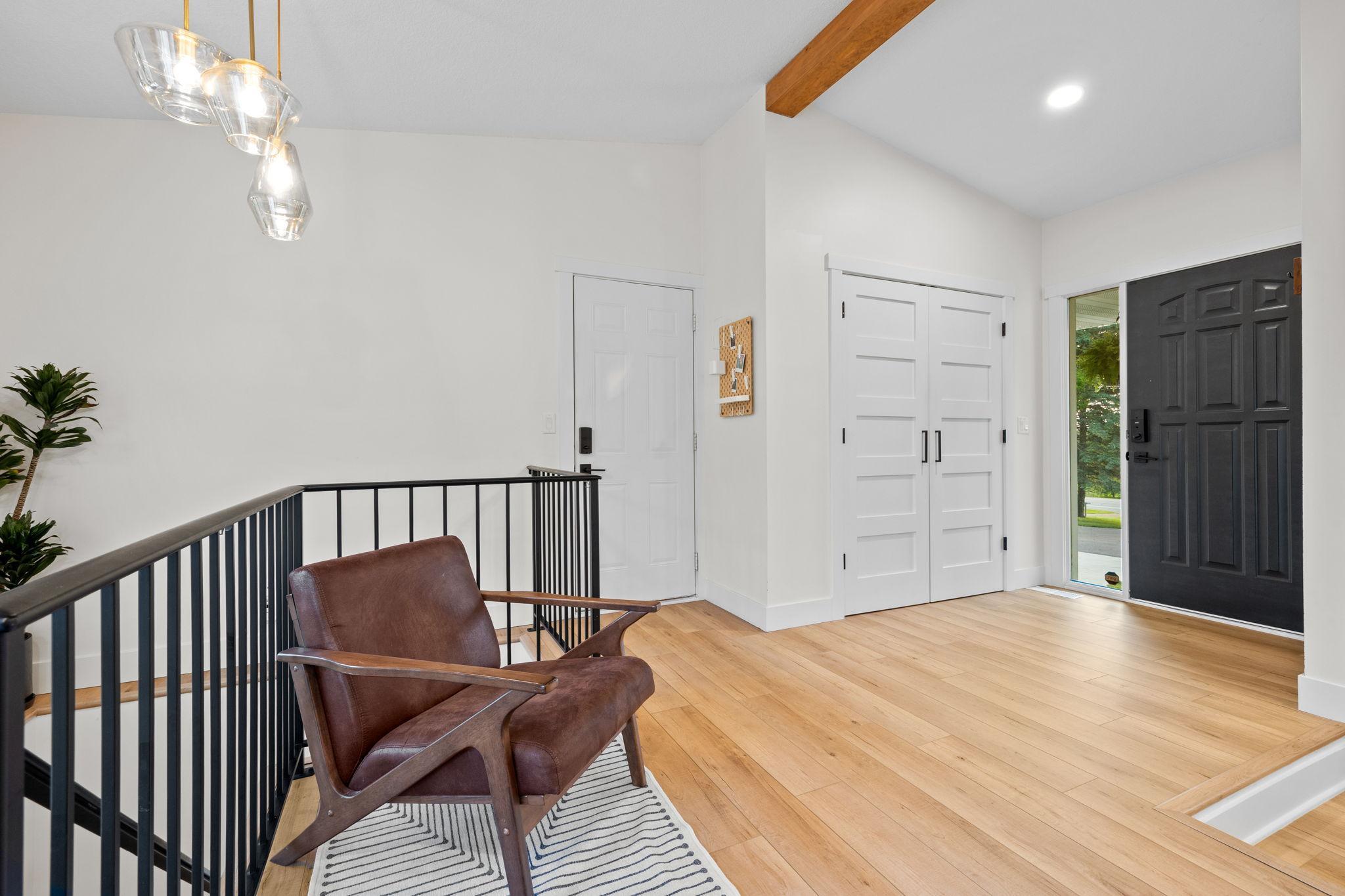 Front entry with closet organization system and access to attached garage.