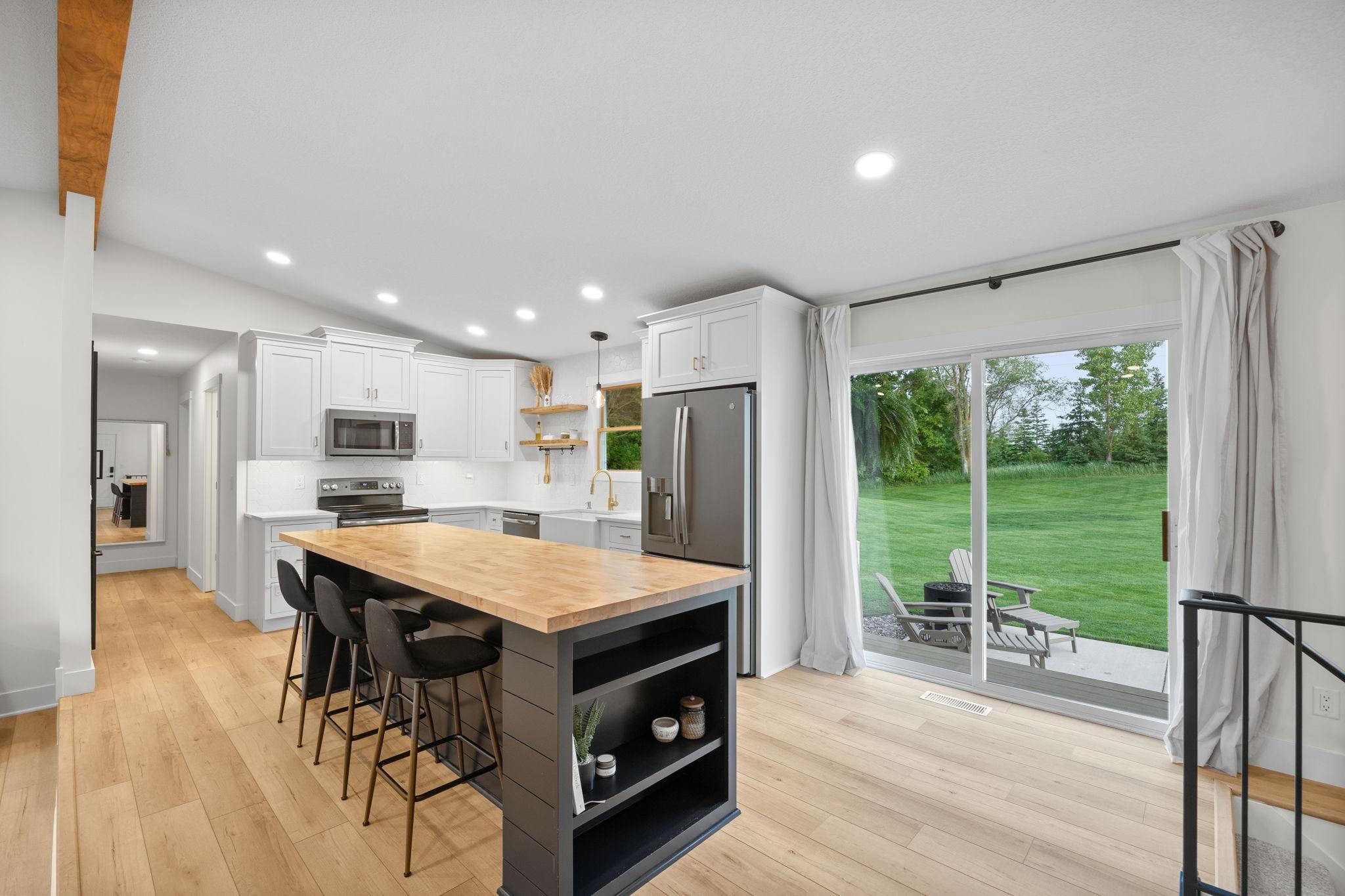 Knockdown ceilings, recessed lighting, LVP flooring, rod iron railings.