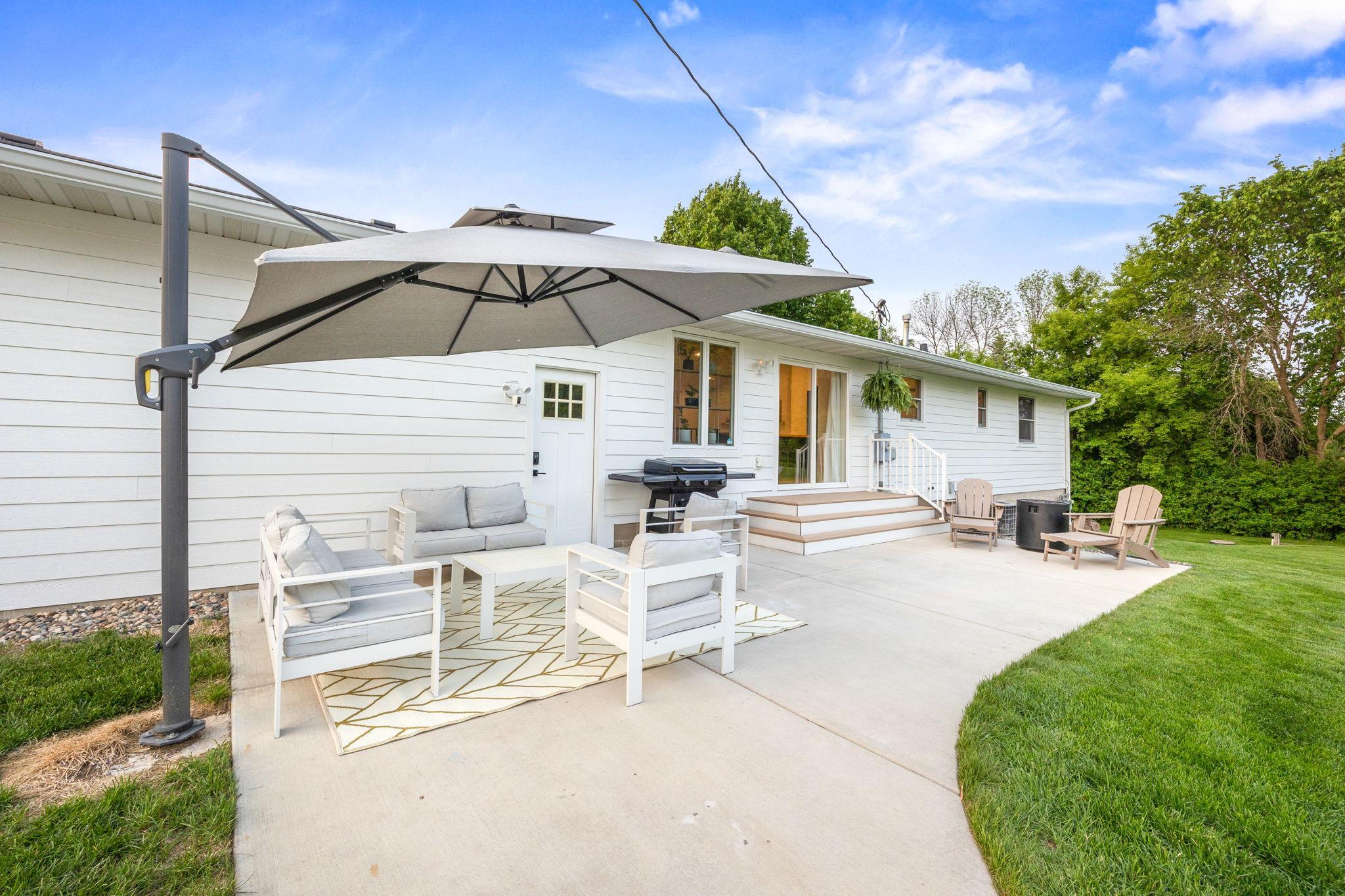 29x14 patio space with permanent umbrella that has adjustable angels and swiveling coverage.