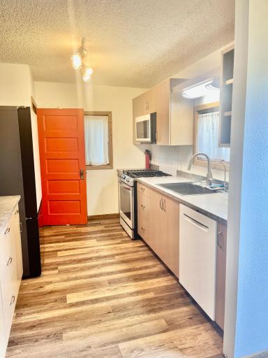 This original door to the basement gives the room character with it's bold pop of color!