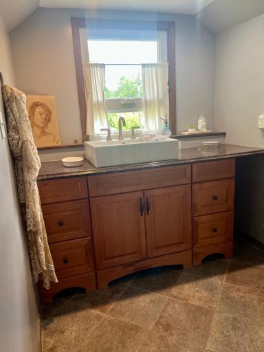 Decorated upstairs 3/4 bath with renovated farm-style sink & awning window.