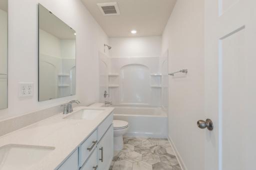 (*Photo of similar home, actual homes colors and finishes will vary) The spacious secondary bathroom