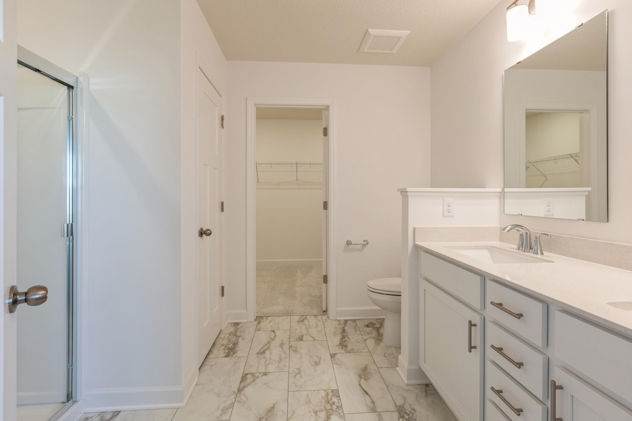 (*Photo of similar home, actual homes colors and finishes will vary) The primary bathroom offers a large double vanity - providing plenty of space for everyone to get ready in the morning!