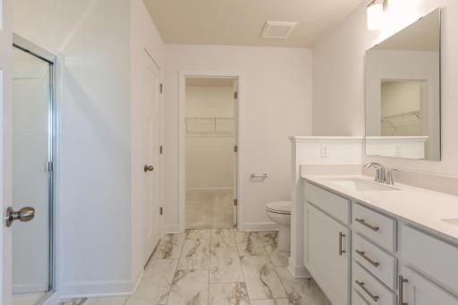 (*Photo of similar home, actual homes colors and finishes will vary) The primary bathroom offers a large double vanity - providing plenty of space for everyone to get ready in the morning!