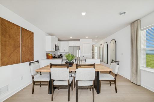 (Photo of the model home) The dining room is perfect for entertaining or having a family meal together.