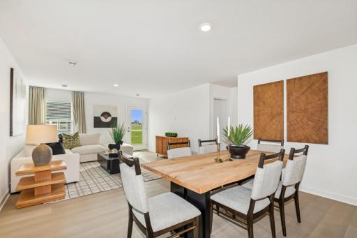 (Photo of the model home) The dining room area transitions seamlessly into the open and spacious great room area.