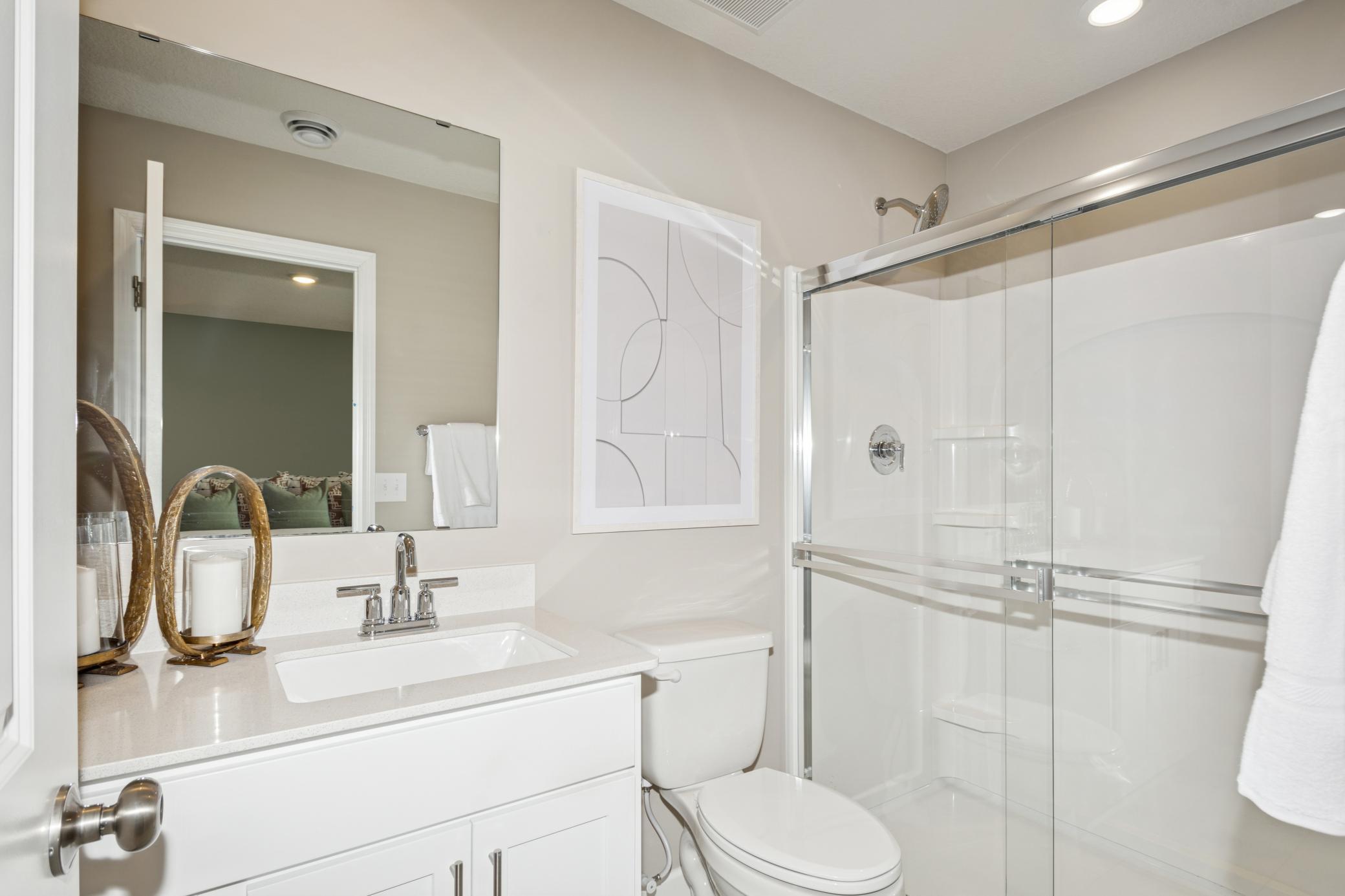 (Photo of the model home) The primary ensuite bathroom offers a spacious shower and attached walk-in closet!