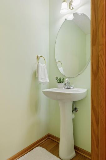 Main floor half bath, hardwood floors, pedestal sink.