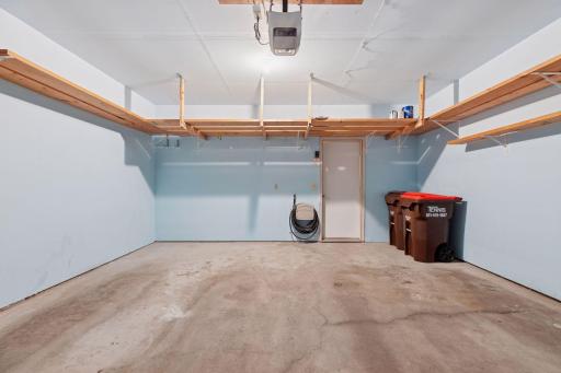 Finished and painted 2 2-car garage. Hose faucet is conveniently located on back wall. Built-in reinforced shelving!