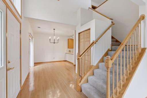 Welcoming front entry with hardwood floors and large coat closet.