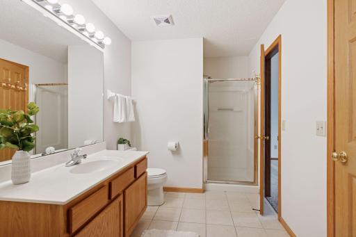 Walk through upper level full bath with separate shower and jetted tub. Tiled floors.