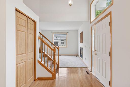 Sightlines from entryway to living room and dining/kitchen areas. The transom window and sidelight provide additional natural light.