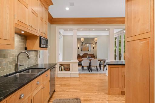 Just off the kitchen is a bright informal dining room with French doors to the back yard deck and paver patio.