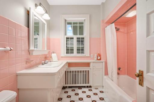 Full bath with original pink ceramic tile.