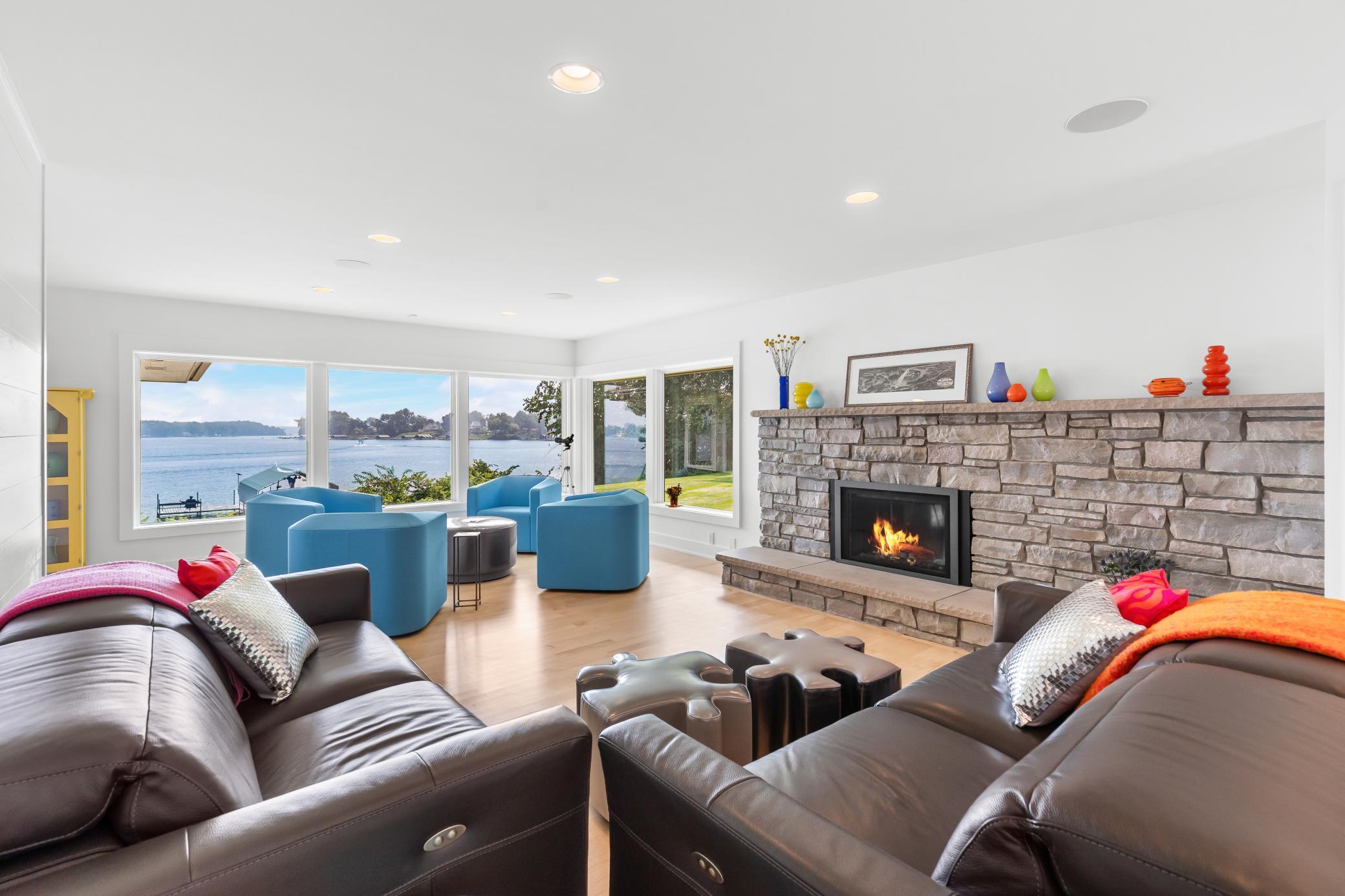 This newly remodeled home's living room features a natural stone fireplace and panoramic views.