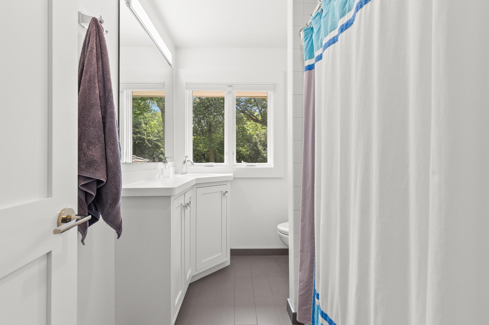 Second level bathroom with Corian countertops.