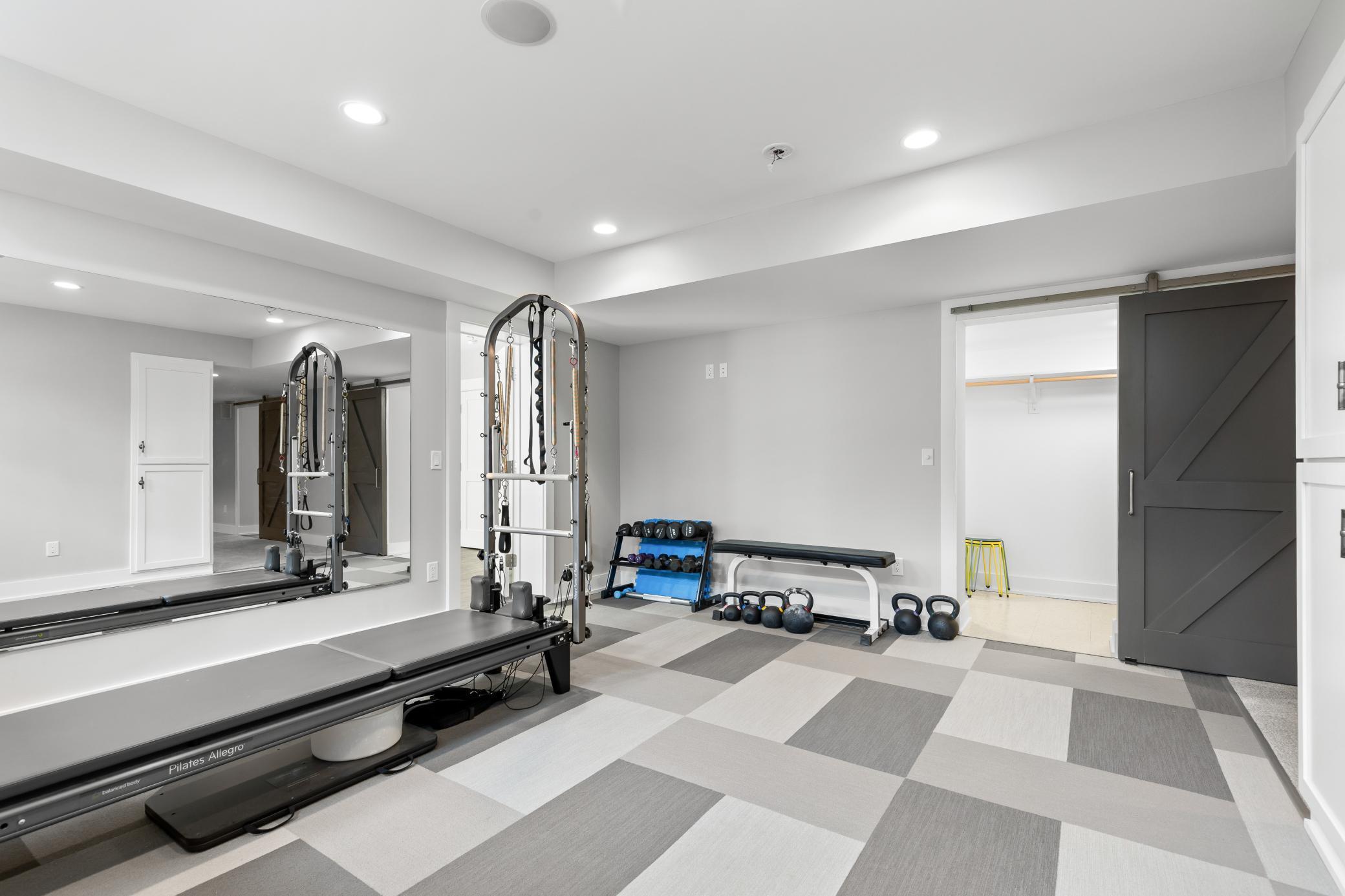 Lower level work out area leads to a potential 6th bedroom and/or office. [ Ample storage possibilities in the lower level - see floor plans.]
