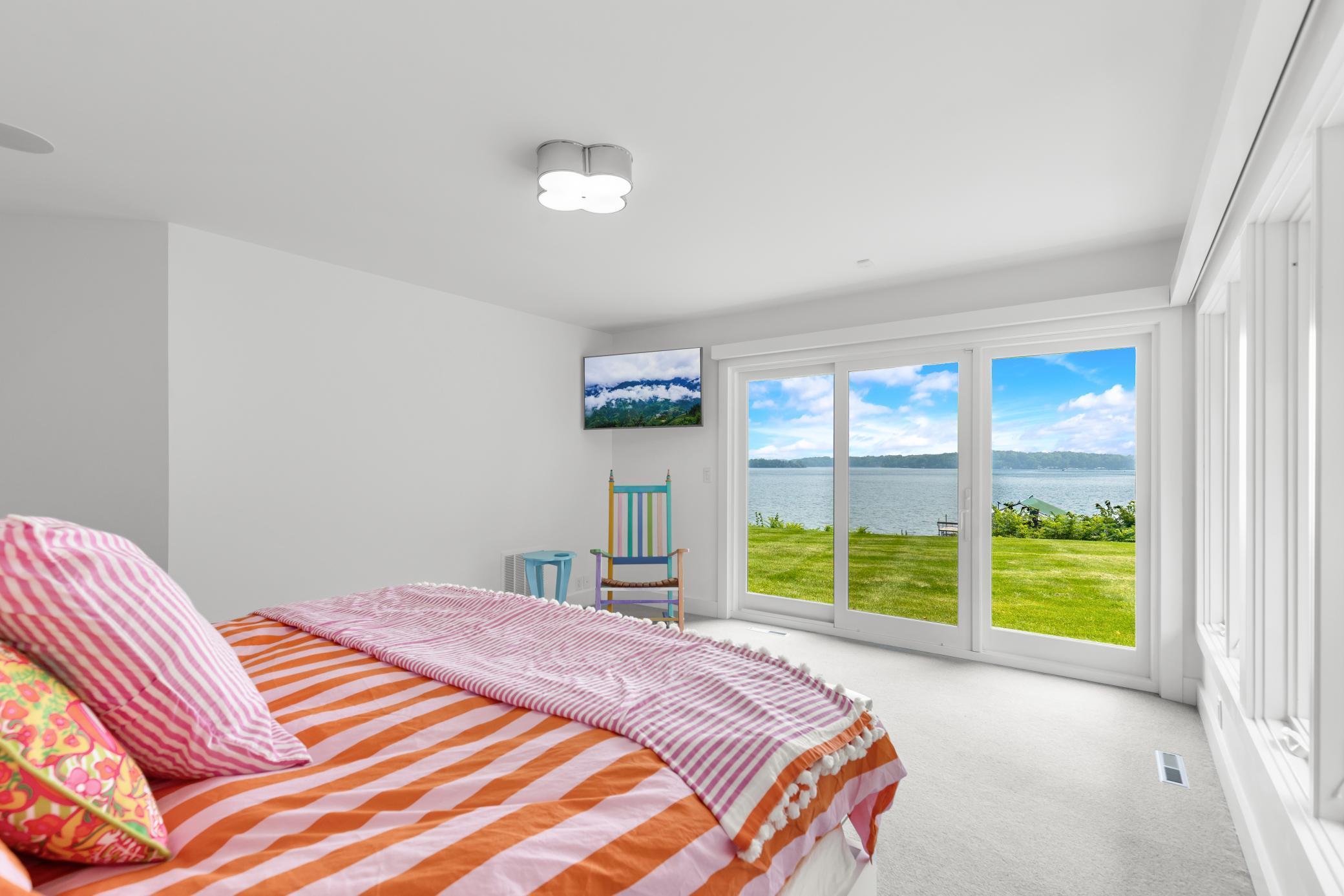 Serene eastern lake views from the primary bedroom.