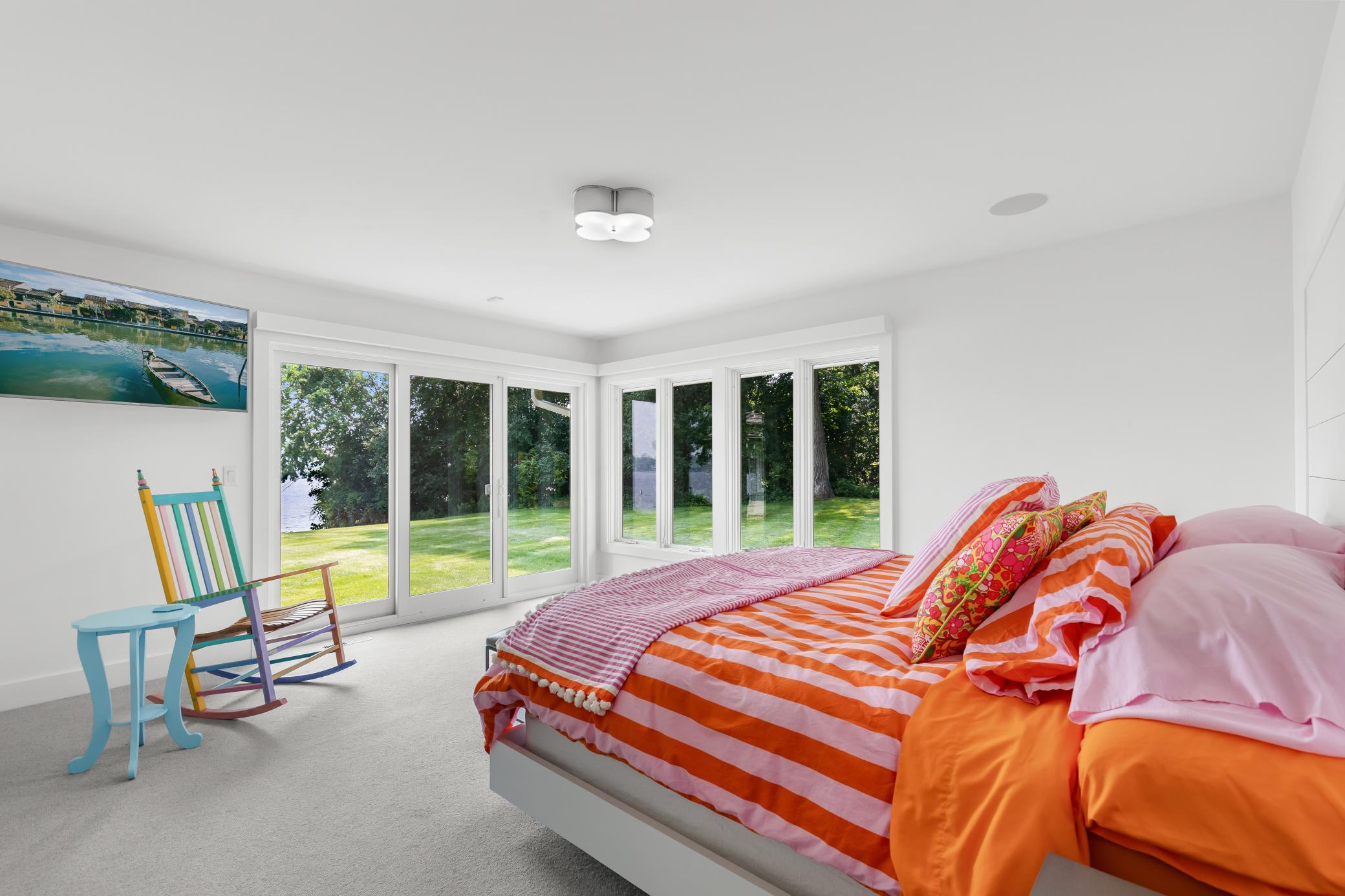 Primary first floor bedroom with floor to ceiling views.