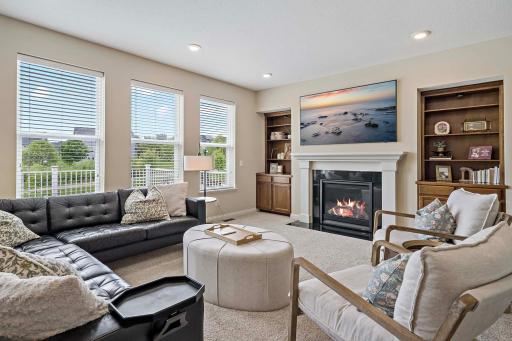 Custom built-ins, window treatments throughout, 9 ft ceilings, tons of natural lights and a fireplace.