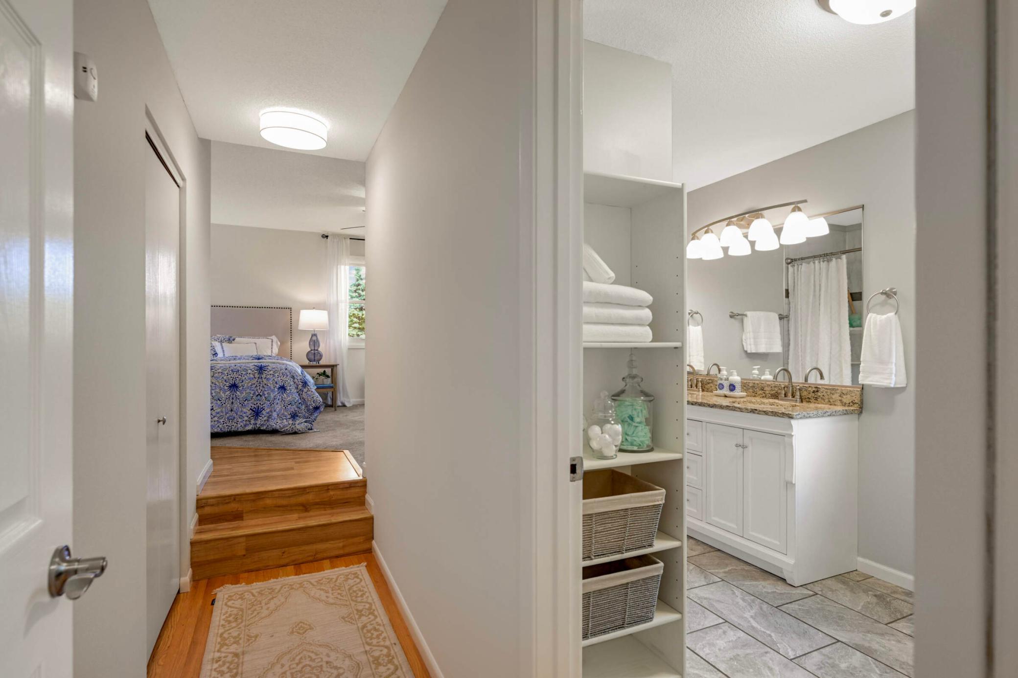 Spacious and private primary bedroom suite features an updated ensuite bathroom with double vanity