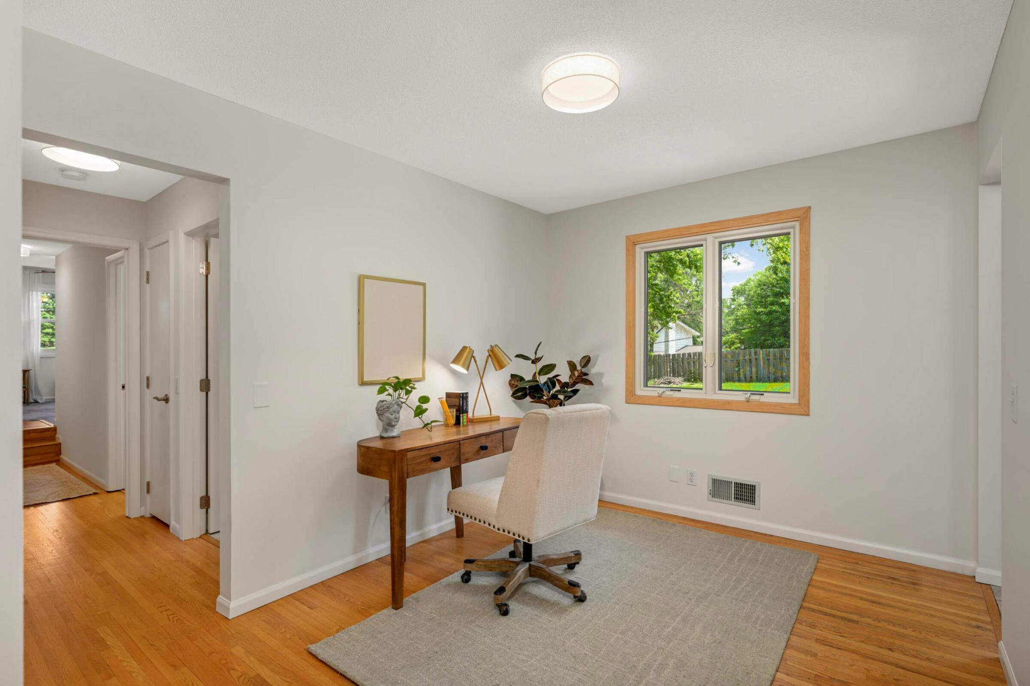 Bright and functional office space just off the kitchen with a large window overlooking the backyard.
