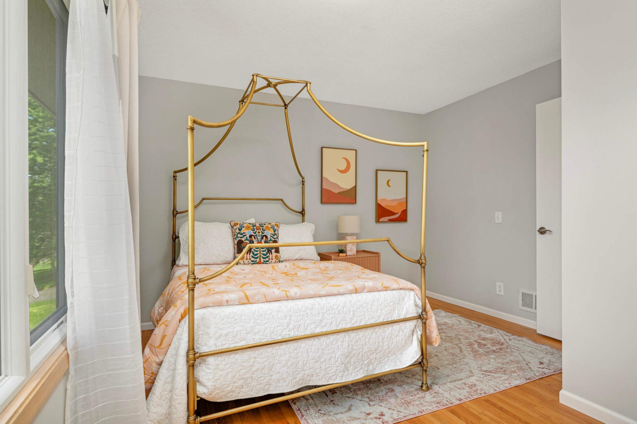 The generous bedroom on the main level features extra large windows, as well as wood floors.