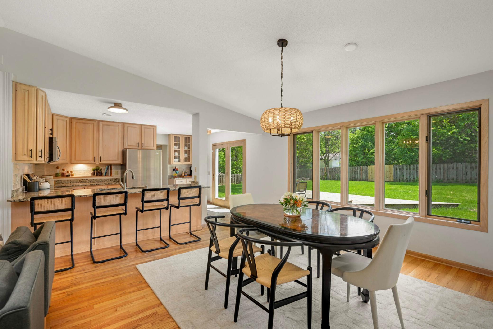 Large windows provide abundant natural light and a beautiful view of the large private fenced backyard.