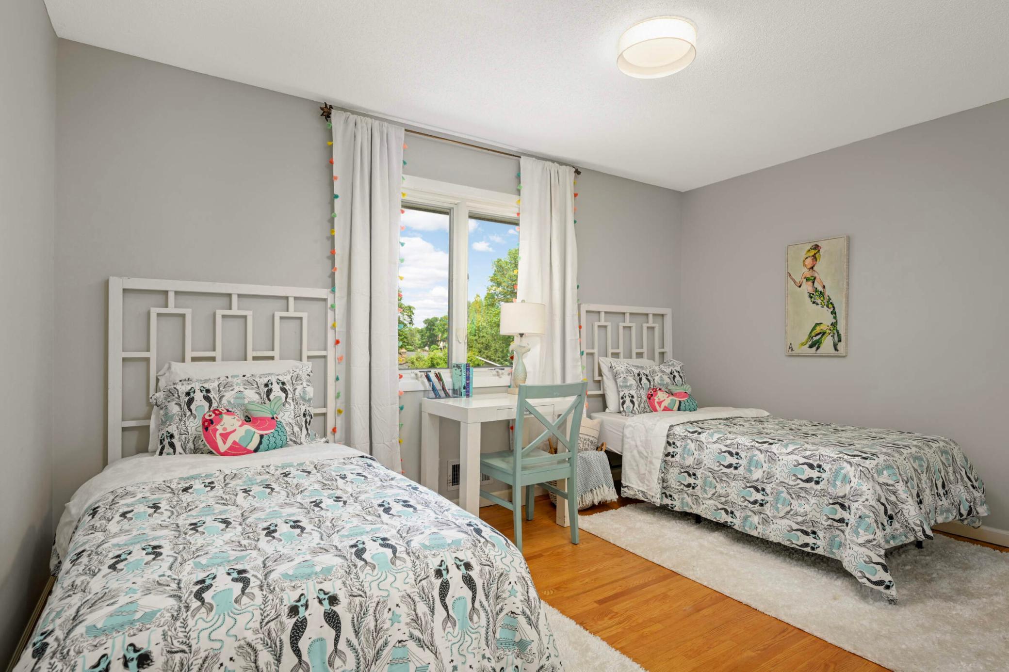 This spacious room is the 2nd of 3 bedrooms on the main level, featuring hardwood floors and ample natural light