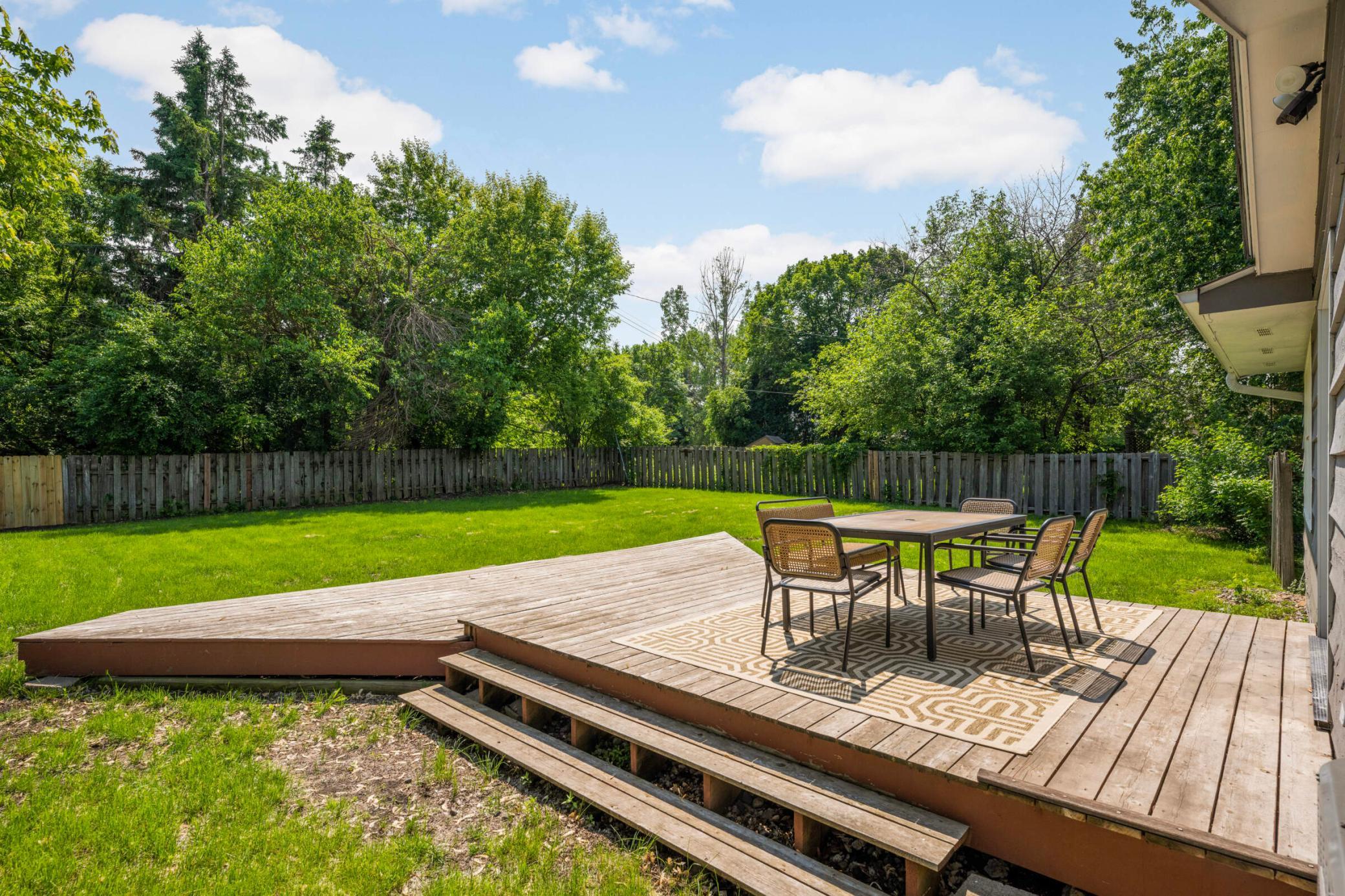 oy outdoor dining and entertaining on the spacious deck overlooking a private, tree-lined fenced backyard.