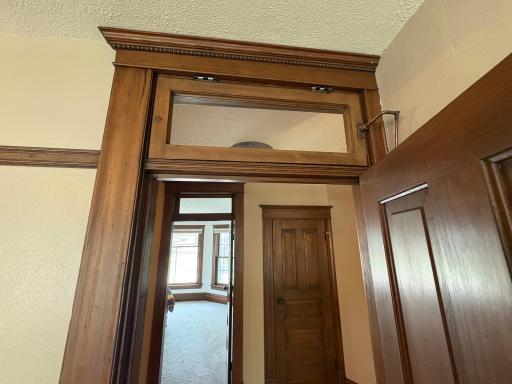 Bedroom Doors have great detail in the woodwork trim along with operational Transom windows