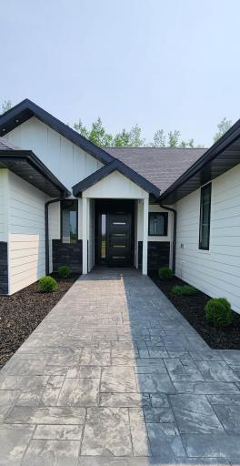 Stamped concrete sidewalk adds an inviting elegance to the walkway.
