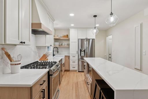 Quartz countertops, custom cabinets, sleek stainless steel appliances