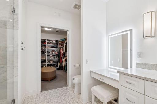 Additional highlights include lighted vanity area and large walk-in closet with built-in organizational components